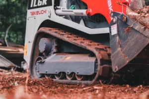 maintain optimal track tension daily to prevent sprocket and idler wear in muddy conditions